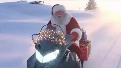 AI Video from prompt: Santa Claus in a red fur coat is riding a snowmo