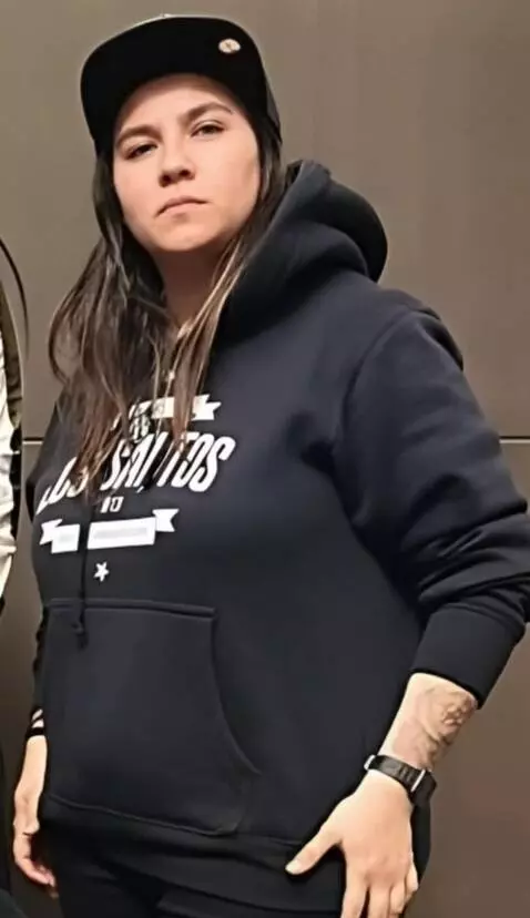 AI Video from prompt: She lifts her shirt and sweater up and shows her