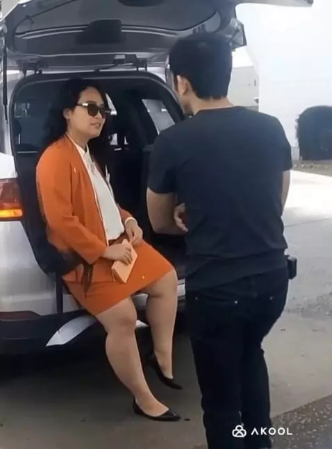 AI Video from prompt: a man approaches a woman while the woman lifts o