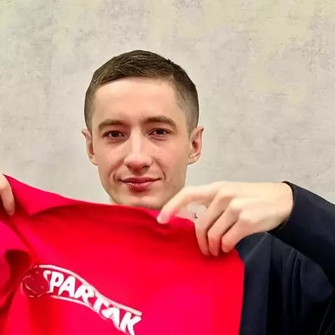 AI Video from prompt: He puts on a red T-shirt of the football sports 