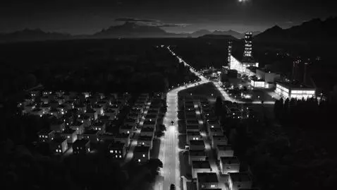 AI Video from prompt: Nighttime aerial shot in stark black and white. 