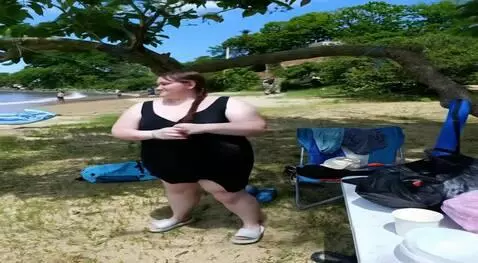 AI Video from prompt: She takes off her clothes, revealing a mini biki