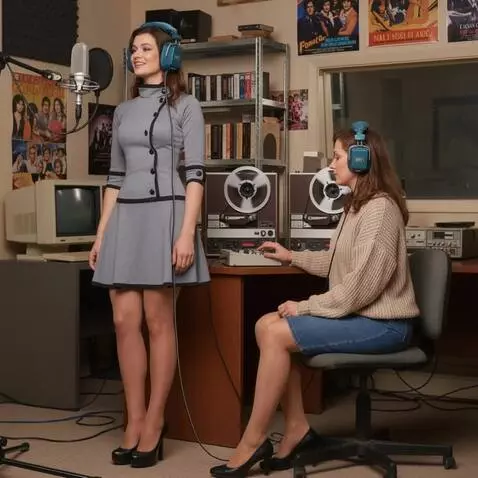 AI Video from prompt: A woman with headphones is singing. The camera r