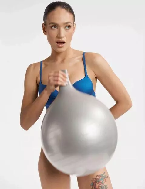 AI Video from prompt: women from photo blowing yoga ball