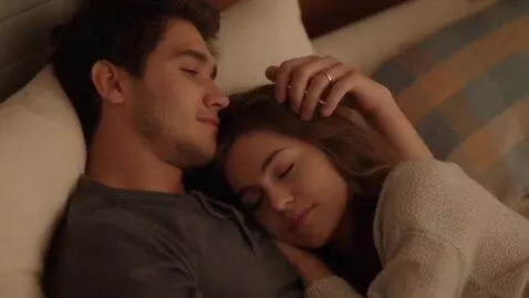 AI Video from prompt: A young man gently strokes the hair of a sleepin