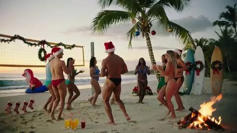 AI Video from prompt: Vibrant Christmas beach party at golden hour, di