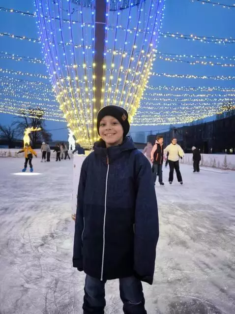 AI Video from prompt: The boy in the photo smiled and waved, greeting 