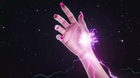 AI Video from prompt: From complete darkness, an elegant feminine hand