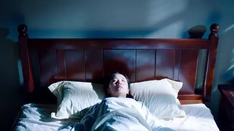 AI Video from prompt: An overhead shot of a woman sleeping peacefully 