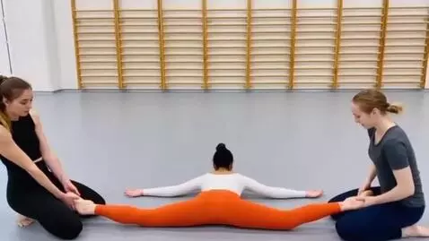 AI Video from prompt: Gymnast A lies on her back on the ground, her up