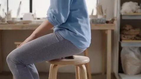 AI Video from prompt: A woman in leggings sitting on a clay figure on 