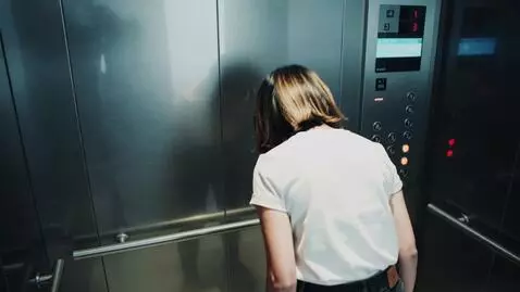 AI Video from prompt: A girl standing in the elevatorz screams to put 