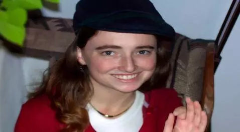 AI Video from prompt: Zoom out as she stands.