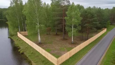 AI Video from prompt: Video from a quadrocopter around a land plot wit