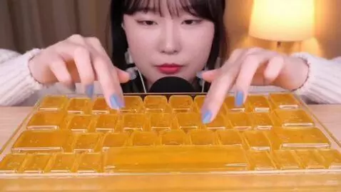 AI Video from prompt: A girl taps on a soft keyboard made of honey ASM
