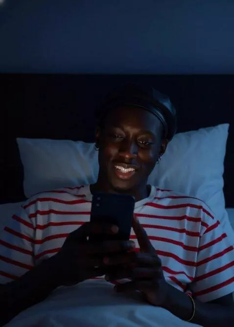 AI Video from prompt: Let him be chatting on his bed with the contrast