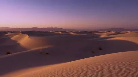 AI Video from prompt: Cinematic shot of a desert dunes at twilight, ca