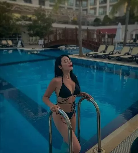 AI Video from prompt: The girl in the photo takes a deep breath, makin