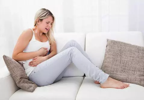 AI Video from prompt: The girl has a very bad stomach ache. She was se