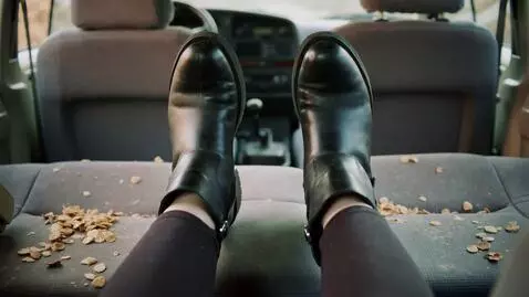 AI Video from prompt: alexandria ocasio cortez on a seat in a dirty ca