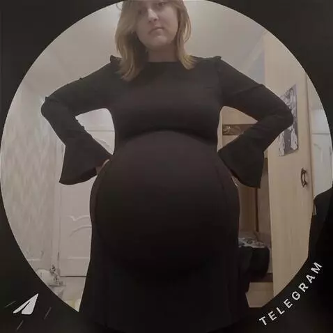 AI Video from prompt: The girl's belly fills with water, becoming larg