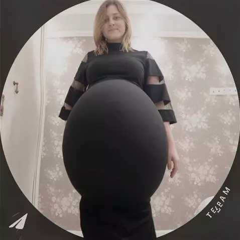 AI Video from prompt: The girl's belly fills with water, becoming larg