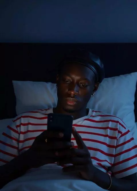 AI Video from prompt: Make him sit on the bed stressed, Moody and hold