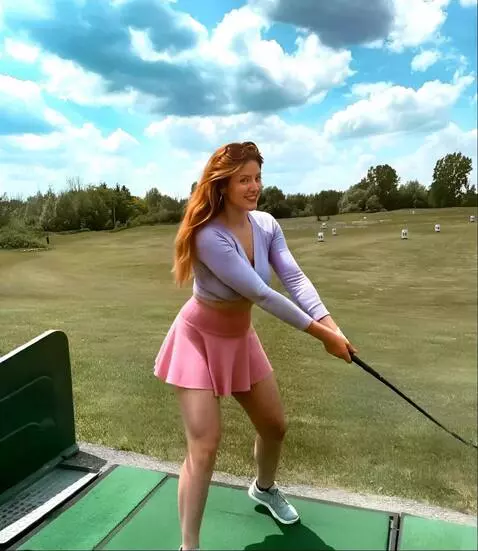 AI Video from prompt: A golfer in a skirt spreads her legs wide and hi