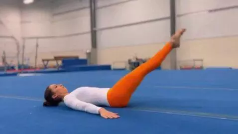 AI Video from prompt: gymnast lying on the back, legs raised in the ai