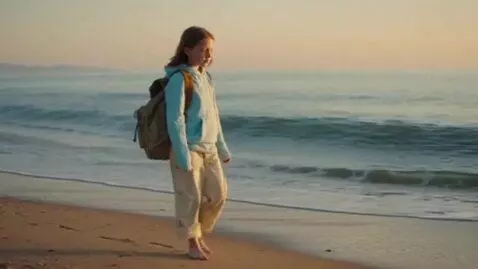 AI Video from prompt: twelve year old girl walking on beach