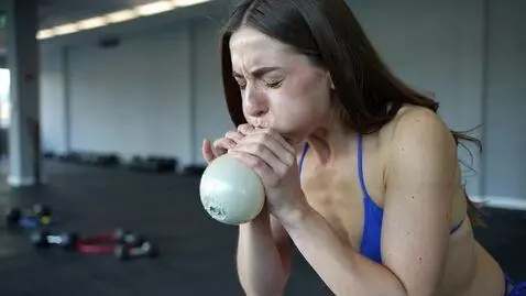 AI Video from prompt: Women at 20 years in blue bikini blowing gym bal