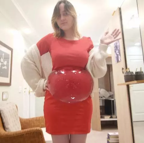 AI Video from prompt: The girl's belly fills with water, becoming larg