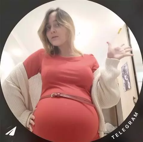 AI Video from prompt: The girl's belly fills with water, becoming larg