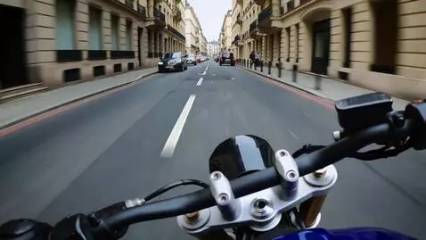 AI Video from prompt: Handlebar-mounted POV camera on a superbike at e