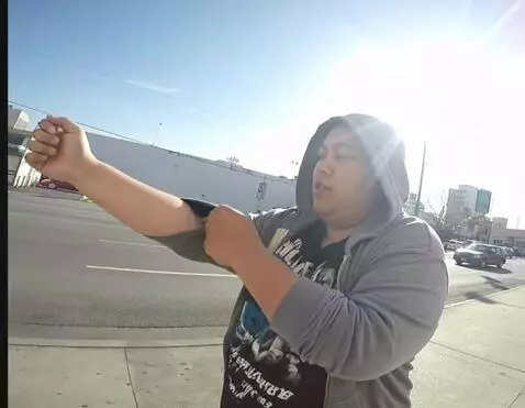 AI Video from prompt: The woman rolling up both hoodie sleeves all the