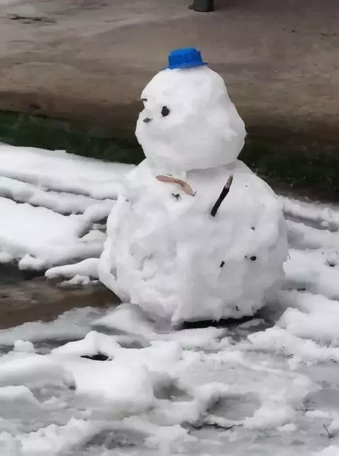 AI Video from prompt: The snowman slides down a slope and falls into a