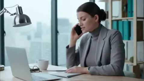 AI Video from prompt: A woman in gray clothes is making a phone call i