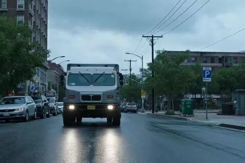 AI Video from prompt: In the foreground, a gray utility truck with its