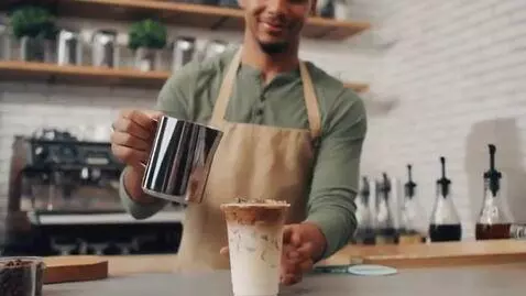AI Video from prompt: Ice Cafe advertisement where a barista makes cof