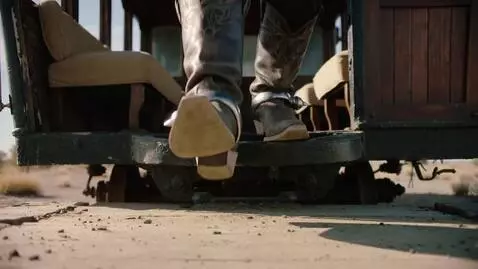 AI Video from prompt: In 1880, a close-up frames a cattle baron's worn