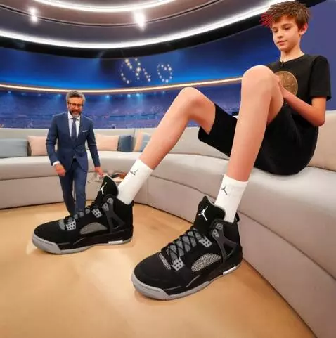 AI Video from prompt: The tall boy moves his legs and the man in the s