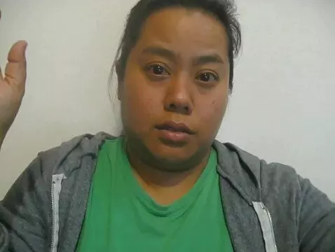 AI Video from prompt: The woman rolls up both of her hoodie sleeves