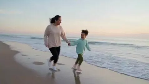 AI Video from prompt: mother and daughter running along the beach
