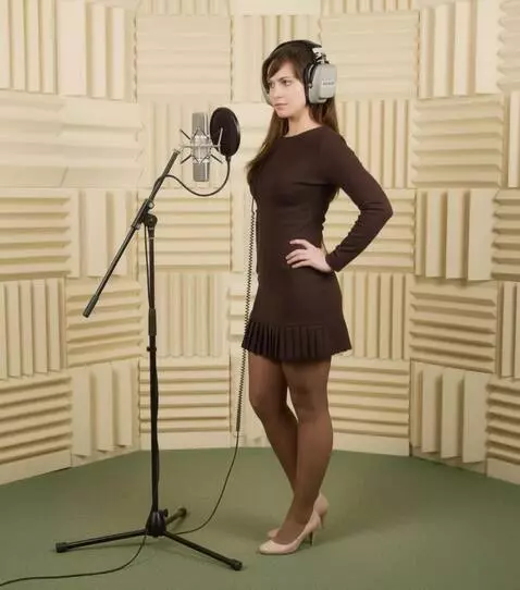 AI Video from prompt: A woman wA young woman in a recording studio. It
