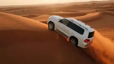 AI Video from prompt: High speed desert safari dune bashing in Dubai, 