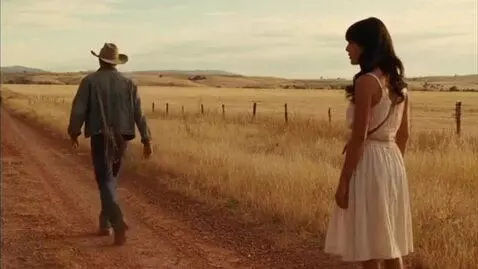 AI Video from prompt: A cowboy walks away from a beautiful woman on th