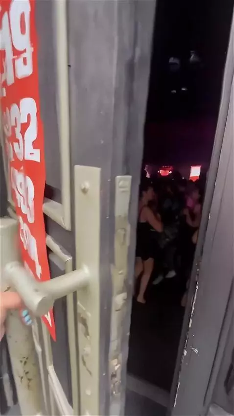 AI Video from prompt: A woman's hand opens the massive door of a night