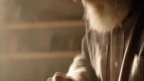 AI Video from prompt: A close-up shot of an elderly artisan carving a 
