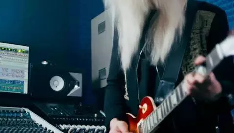 AI Video from prompt: white, long haired, guitar player performing a l