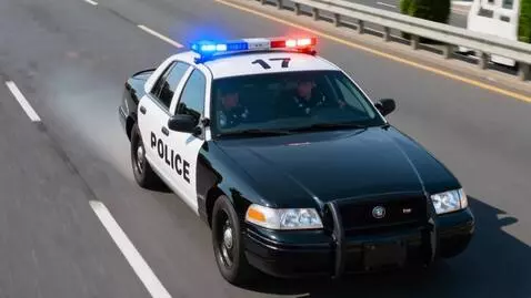 AI Video from prompt: Two Police officers one in the drivers seat and 